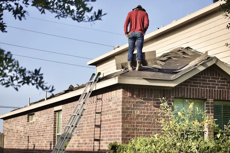 Professional roofer working on a residential roof in Mantoloking